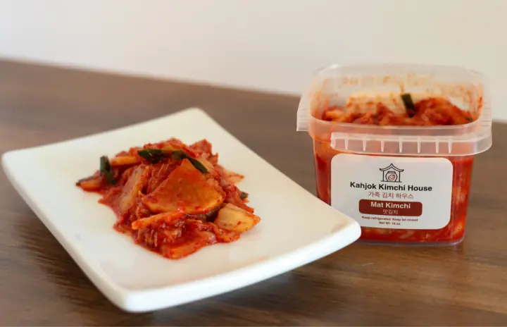 Kahjok Kimchi House Mat Kimchi plated beside its container