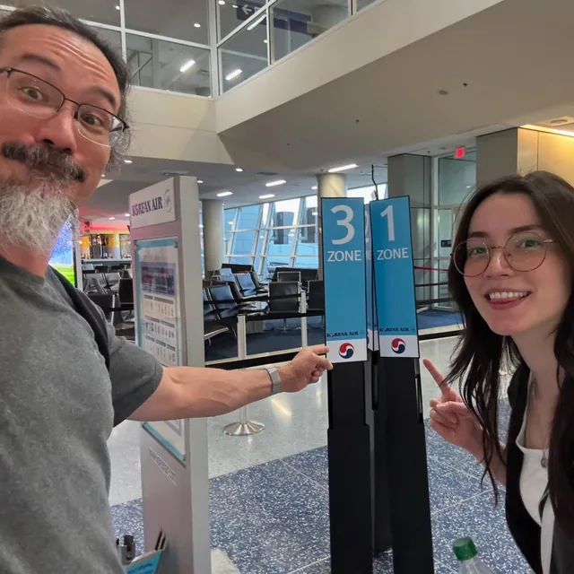 John and Fiona at an airport gate during their 2025 trip to Korea