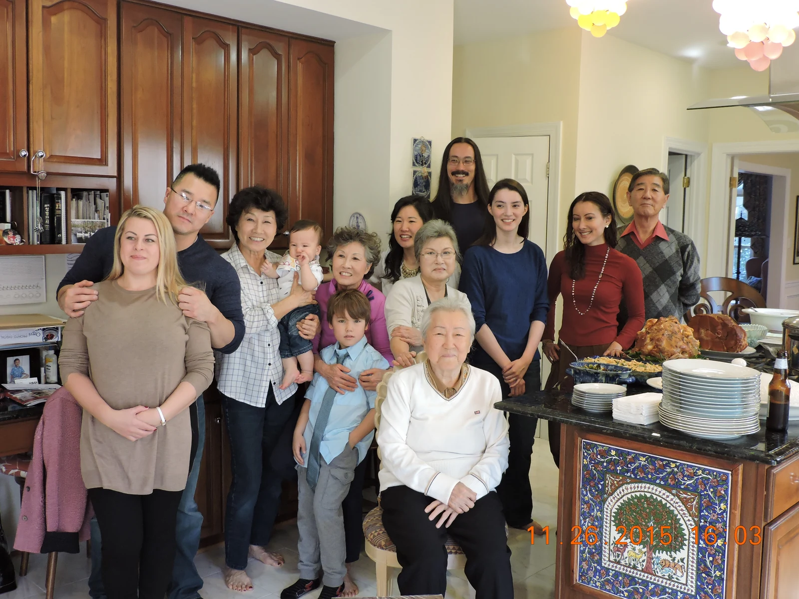 John and Fiona visiting John's mother for Thanksgiving 2015, with many of the Shin family present including John's halmoni