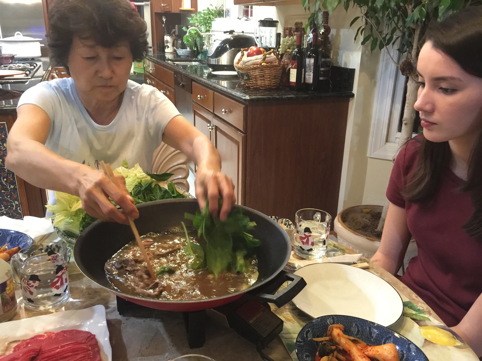 Fiona and her halmoni eating at her halmoni's home in 2015